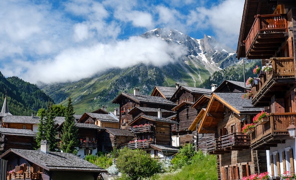 wooden cabin lodges nested in the valley between the Swiss Alps